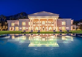 View of the pool and the façade of the villa for sale.