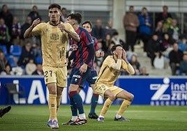 Malaga's Chupete, left, and Juanpe react to a missed opportunity.