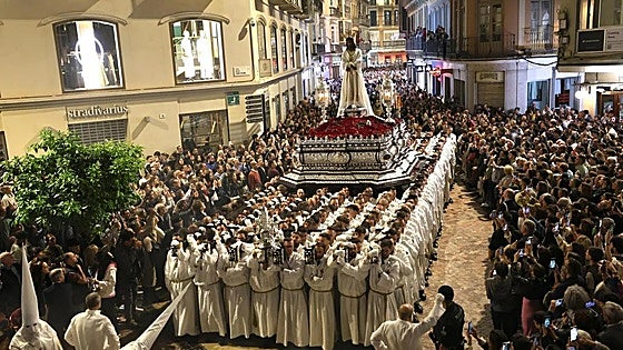 How much money do the spectacular Semana Santa processions bring into Malaga?