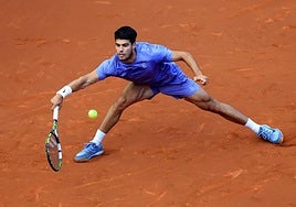 Alcaraz attempts to return a shot during Sunday's final.