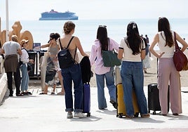 A group of tourists take a look at the sea in Malaga.