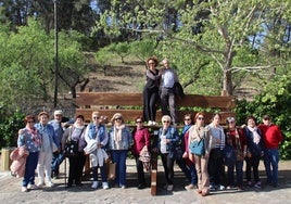 Residents of Cuevas de San Marcos on the giant bench in the town.
