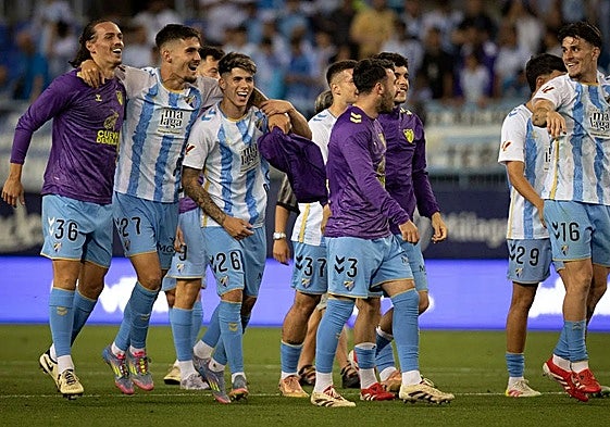 The Malaga players following Saturday's win over Sporting.