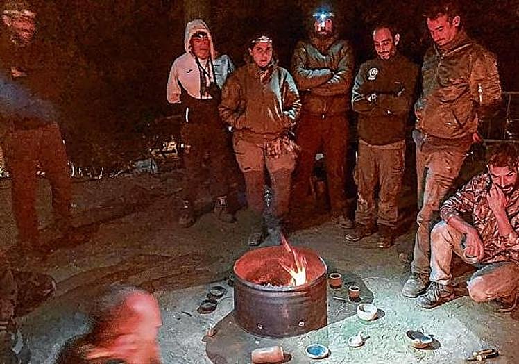 Participants in survival courses learn how to start a fire.