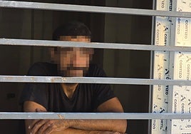 The burglar waiting for the fire brigade in the flat where he was caught.