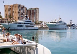 Luxury vessels moored in Malaga port's megayacht marina.