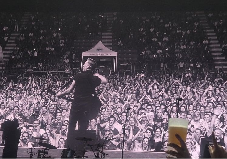 A photo of the stage screen, showing the audience enjoying Bryan Adams.