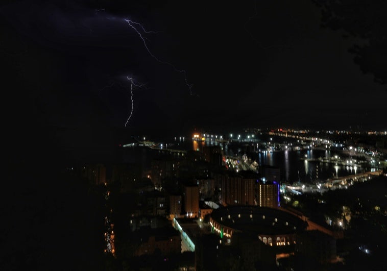 Lightning in the sky over Malaga port, in an image taken from Gibralfaro.