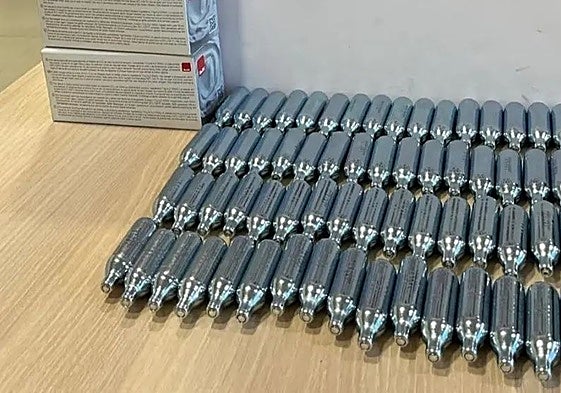 The canisters of nitrous oxide seized during the police action.