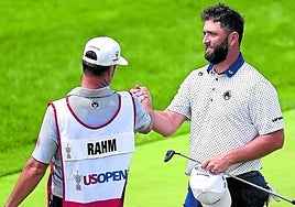 Rahm with his long-term caddie Adam Hayes at the end of the round.