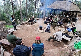 Group of students preparing a meal with food collected from the surrounding area during May's course.