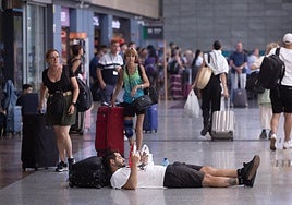 A rail passenger tries to take a break when faced with delayed trains.