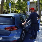 A motorist recharging his electric vehicle.