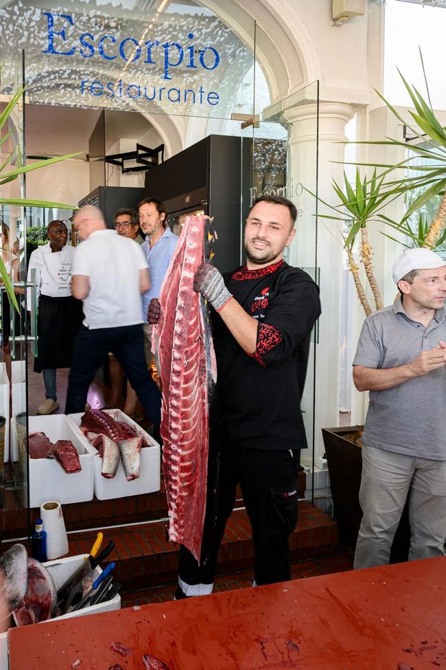 The chef displays the sliced tuna.