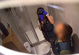 The camera hidden in the bathroom shows the Guardia Civil during the investigation.