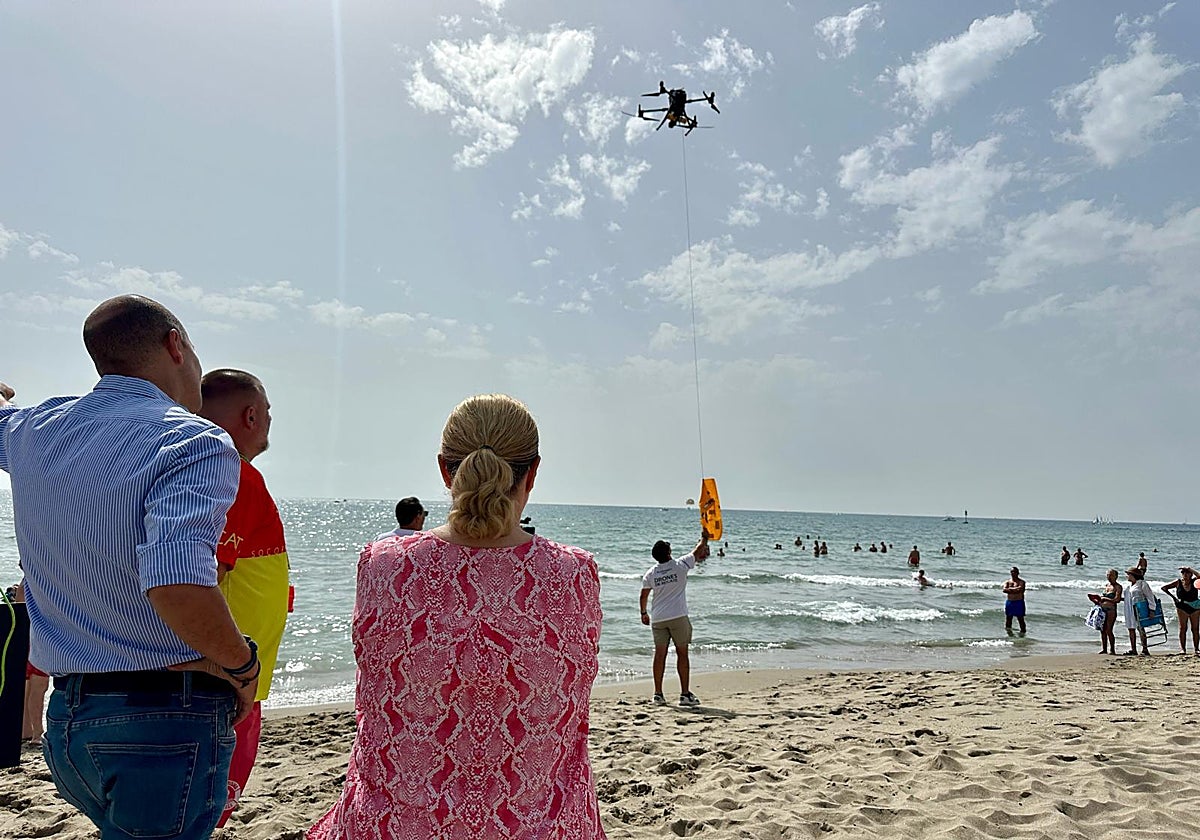 Fuengirola mayor Ana Mula observes the flight of a drone.