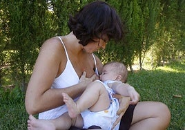 A mother breastfeeds her baby.