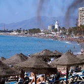 Tourists and locals enjoying beach time in Malaga city.