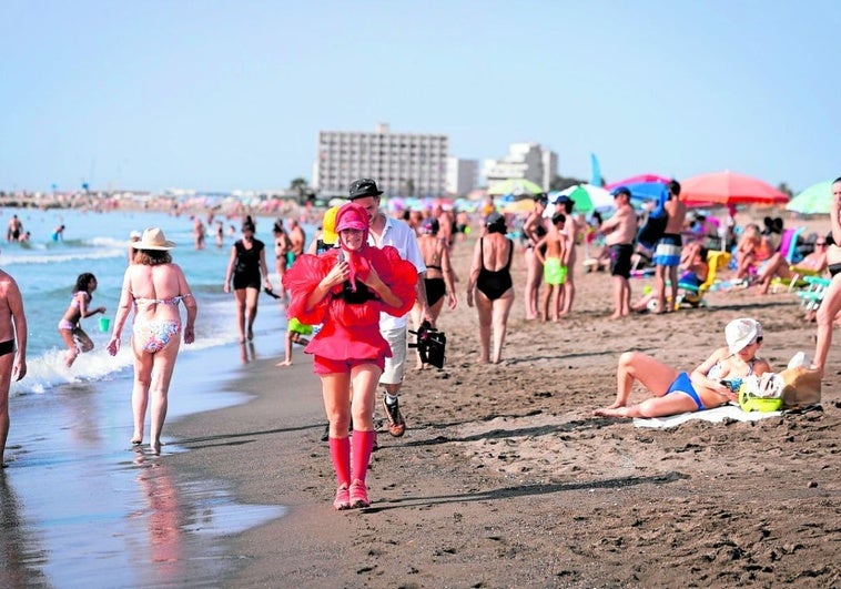 Who is the woman in red walking the length of the Costa del Sol?