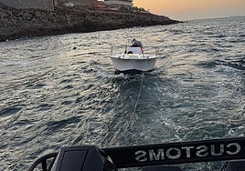The small boat being towed back to the marina.