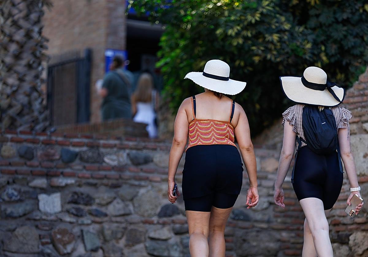 Tourists prepare to explore the Alcazaba during their visit to Malaga city.