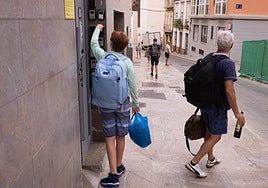 Tourists deposit their keys in the property's secure dropbox after their holiday in Malaga.