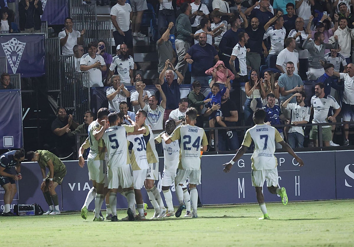 Marbella FC players celebrate the winning goal with their fans.