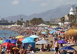 Tourists and locals on La Malagueta beach in Malaga city.