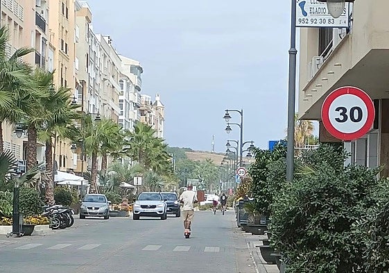 A person riding an electric scooter on Avenida de España in Estepona.