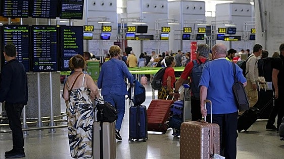 When is the best time to travel to find the cheapest flights at Malaga Airport?