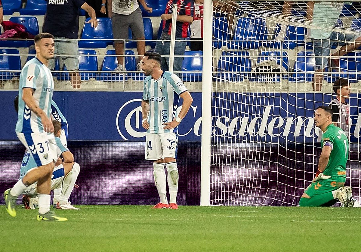 The Malaga defenders having conceded the late winner.