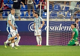 The Malaga defenders having conceded the late winner.
