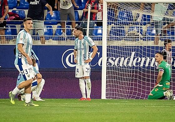 The Malaga defenders having conceded the late winner.