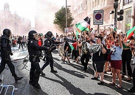 Police try to hold back protesters.