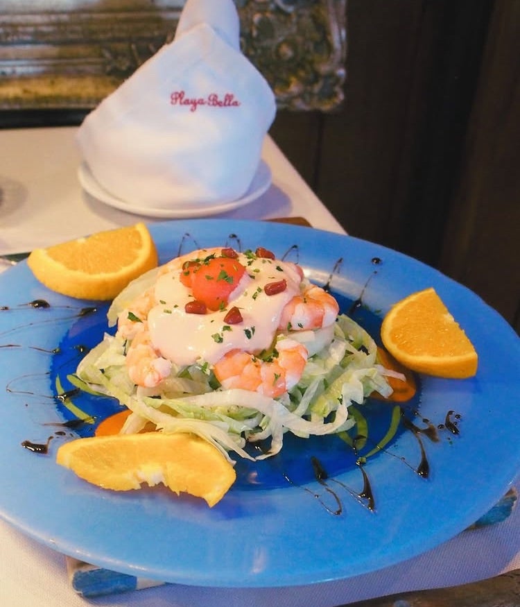 Shrimp Cocktail: Crispy lettuce, soft shrimp, and pink sauce.