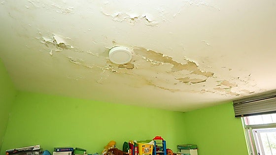 Who can residential community homeowners in Spain claim from if their property is affected by a water leak?