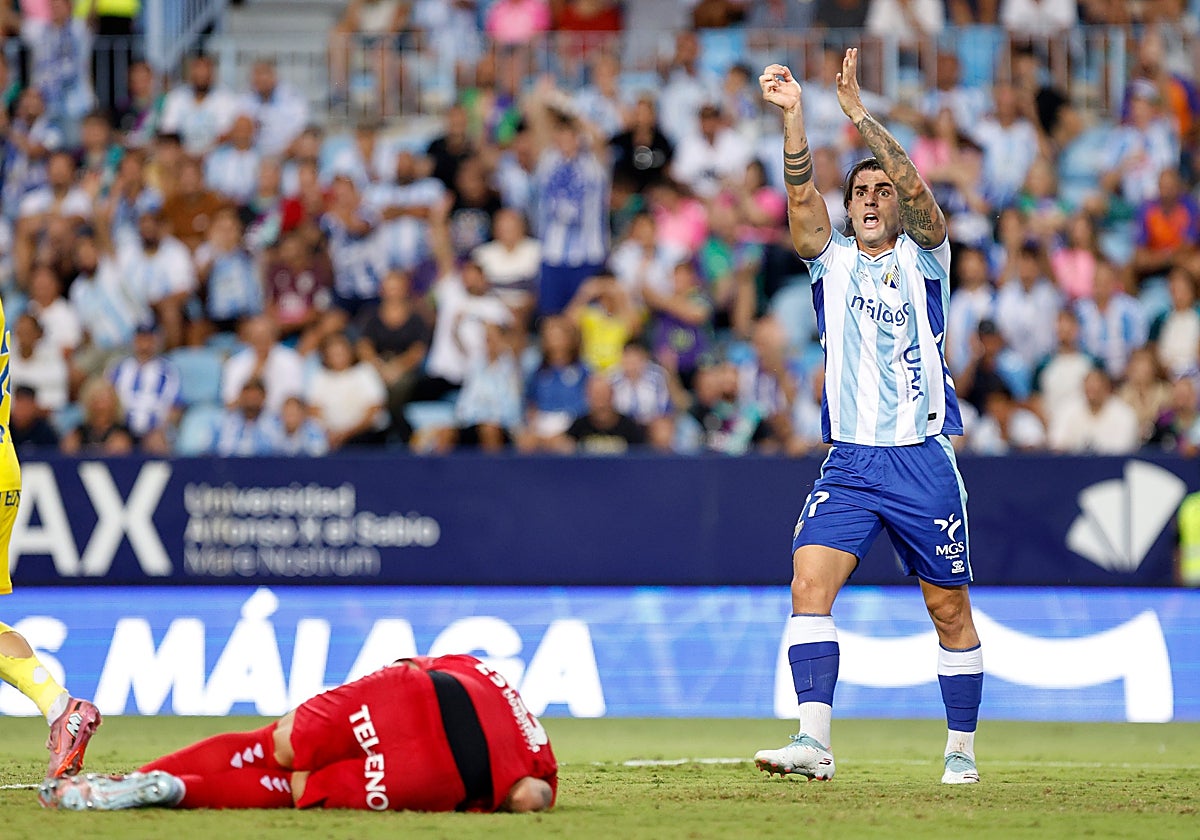 Malaga striker Eneko Jauregi appeals for a late handball.