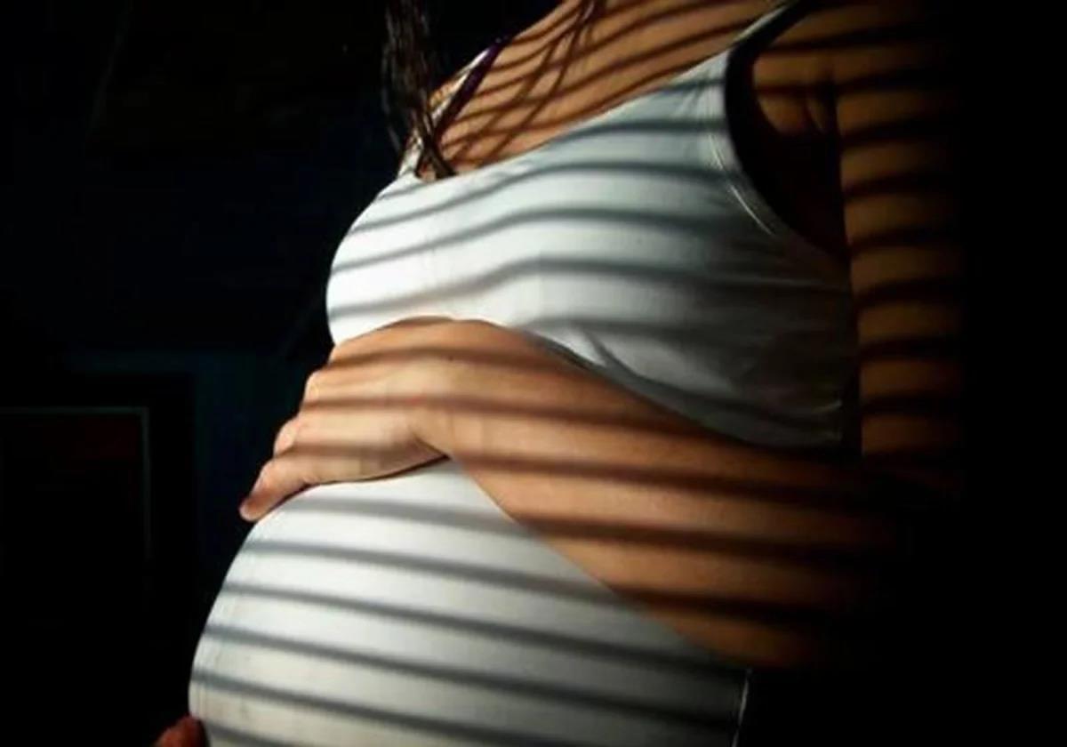 A pregnant young woman.