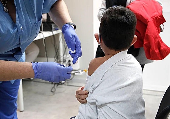 A child receives a coronavirus vaccine.