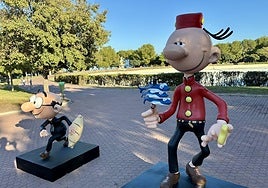 Mortadelo holding a skewer of sardines.