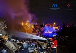 Firefighters extinguish the flames near Casillas de la Vía.