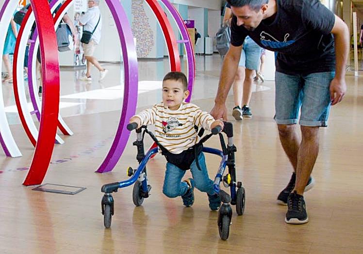 Dani walks in the lobby of the Barcelona hospital.