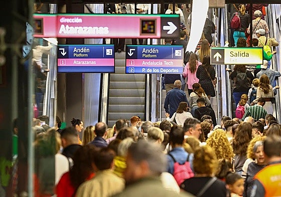 Passengers on the Malaga metro inside a station.