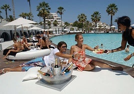 Tourists toast with champagne and snacks at a hotel in Marbella.
