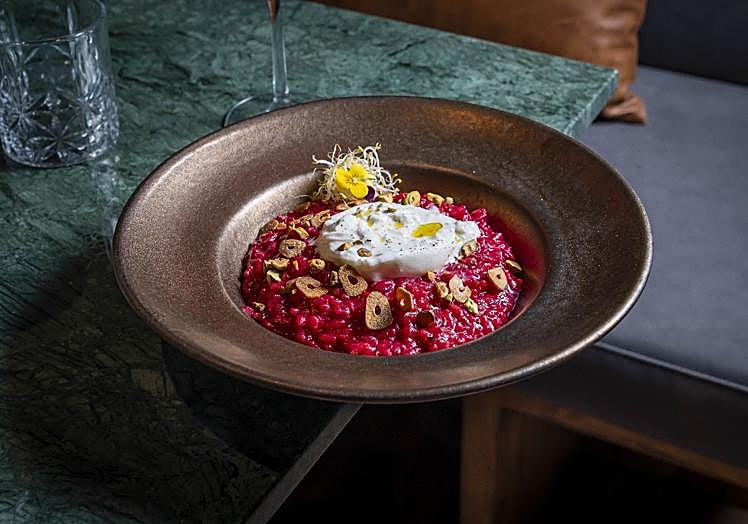 Beetroot risotto: creamy Carnaroli rice, soft burrata, chopped pistachios and fried garlic chips.