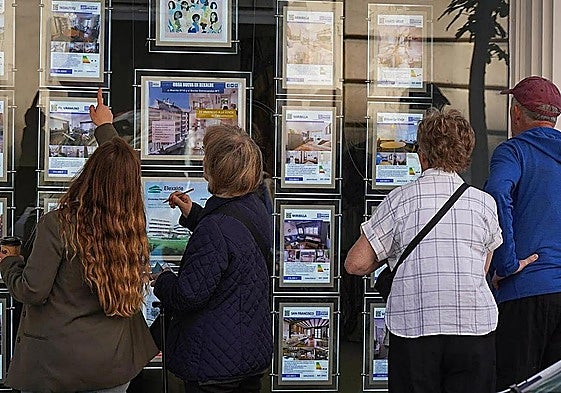 People looking at housing advertisements.