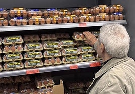A man buys eggs in a supermarket.