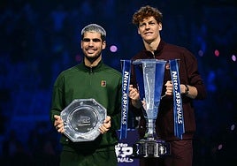 Alcaraz and Sinner with their respective trophies.