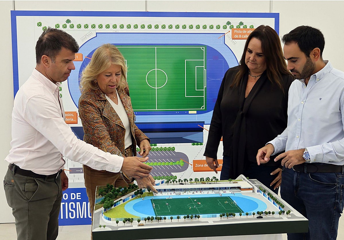 The mayor and councillors look at the model of the stadium.
