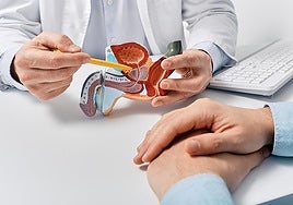 A doctor explains prostate-related issues to a patient.